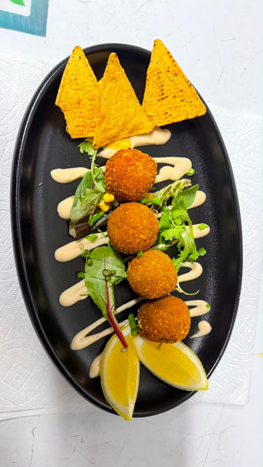 Truffled porcini arancini with salad and lemon