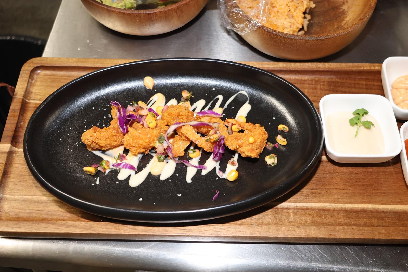 Crispy chicken bites plated at Illumina