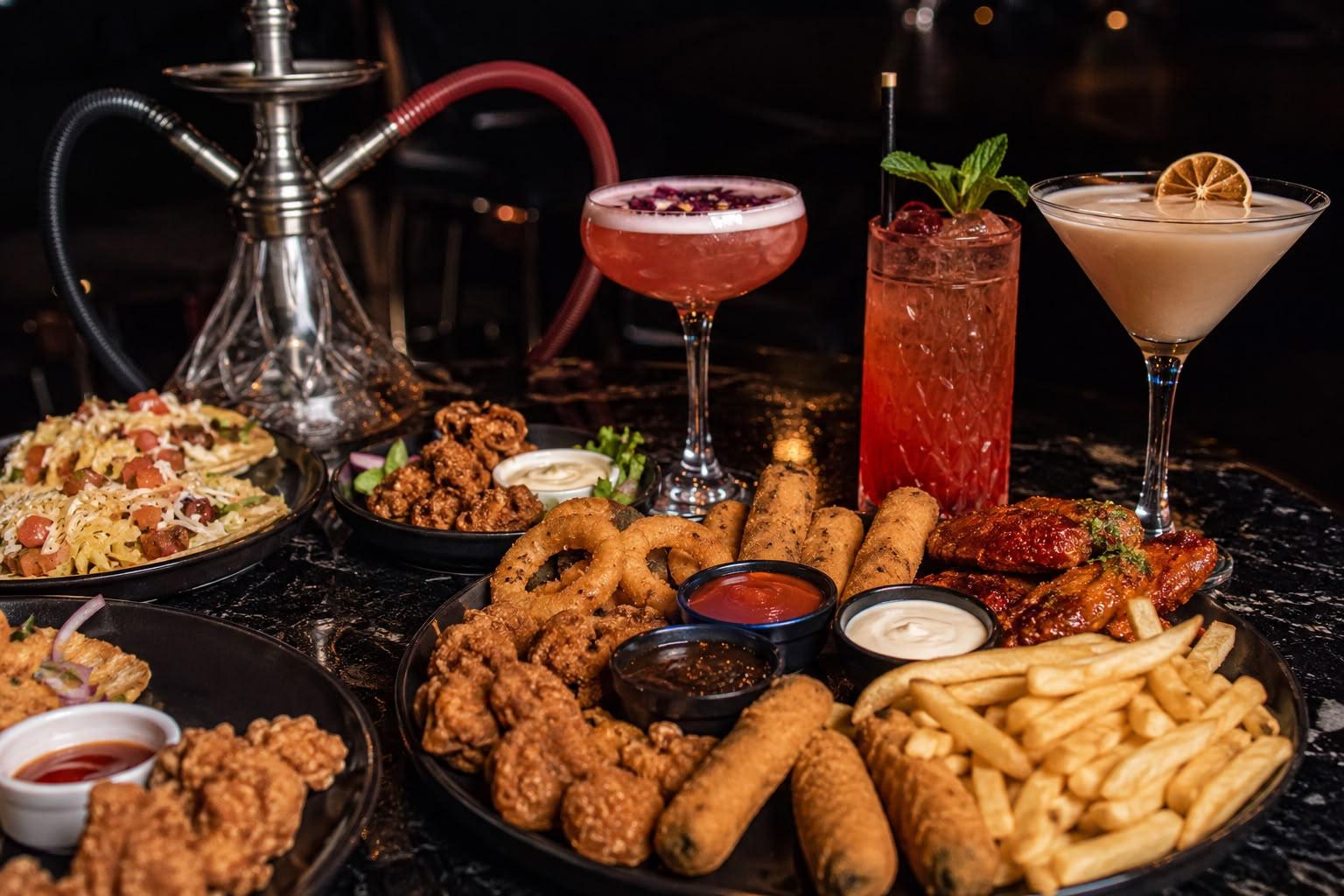 A table at Illumina with share food, elegant drinks and shisha
